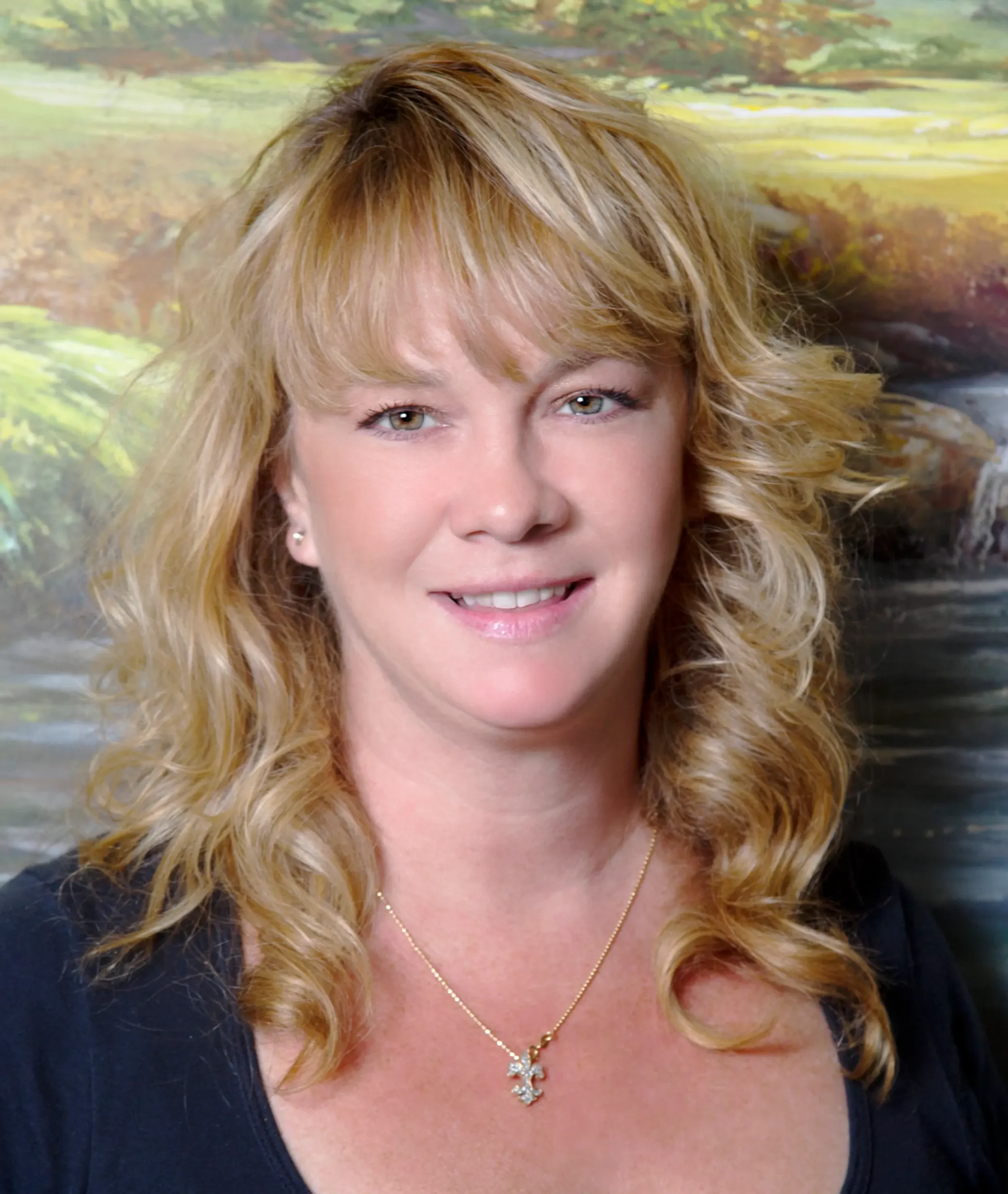 A woman with blonde hair and a cross necklace.